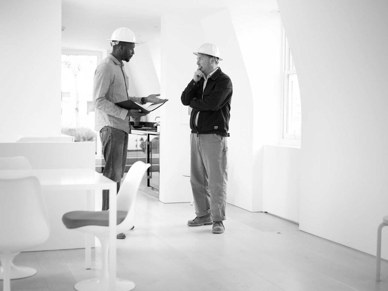 Two people in conversation on site at a residential project